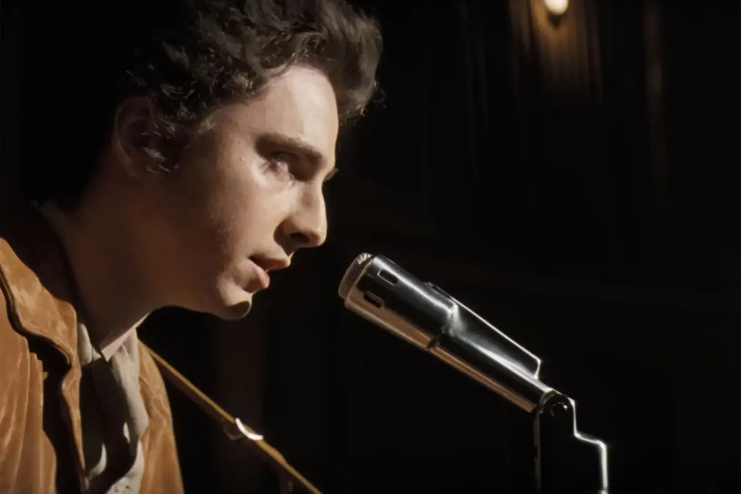 See Timothée Chalamet's Bob Dylan perform "A Hard Rain's A-Gonna Fall" in A Complete Unknown trailer Illustrations
